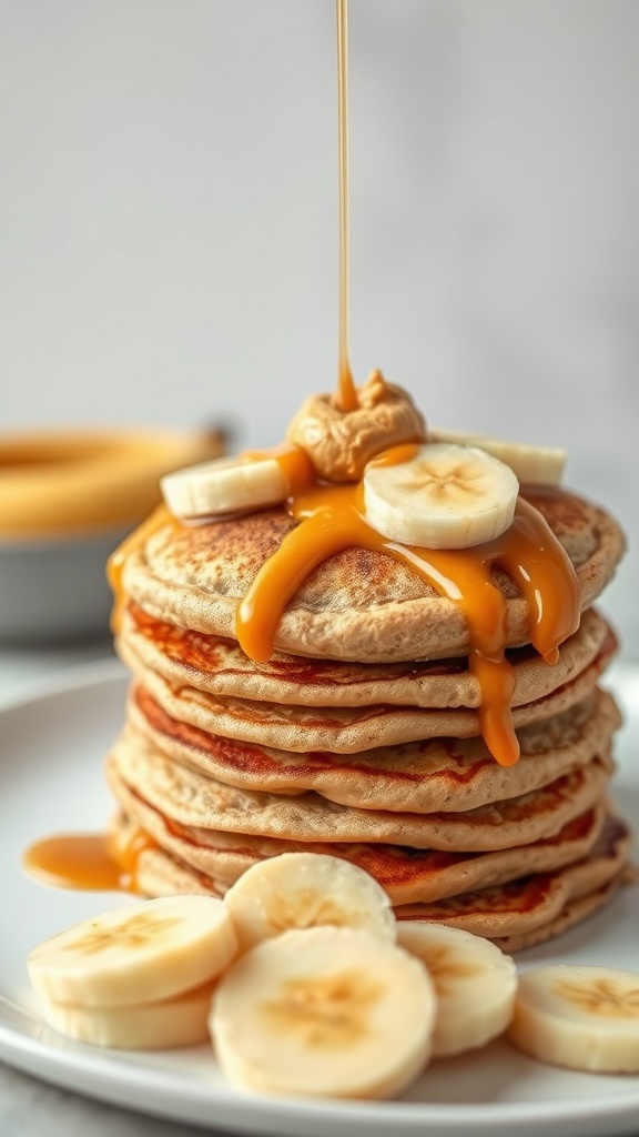 Stack of fluffy peanut butter banana pancakes topped with sliced bananas and syrup.